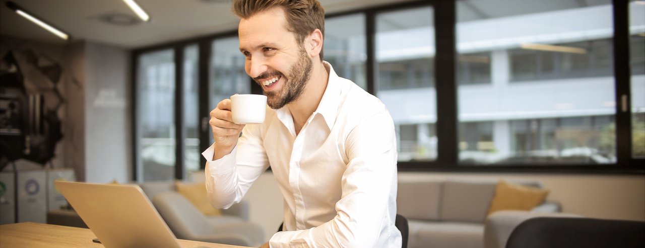 Business man drinking coffee and smiling